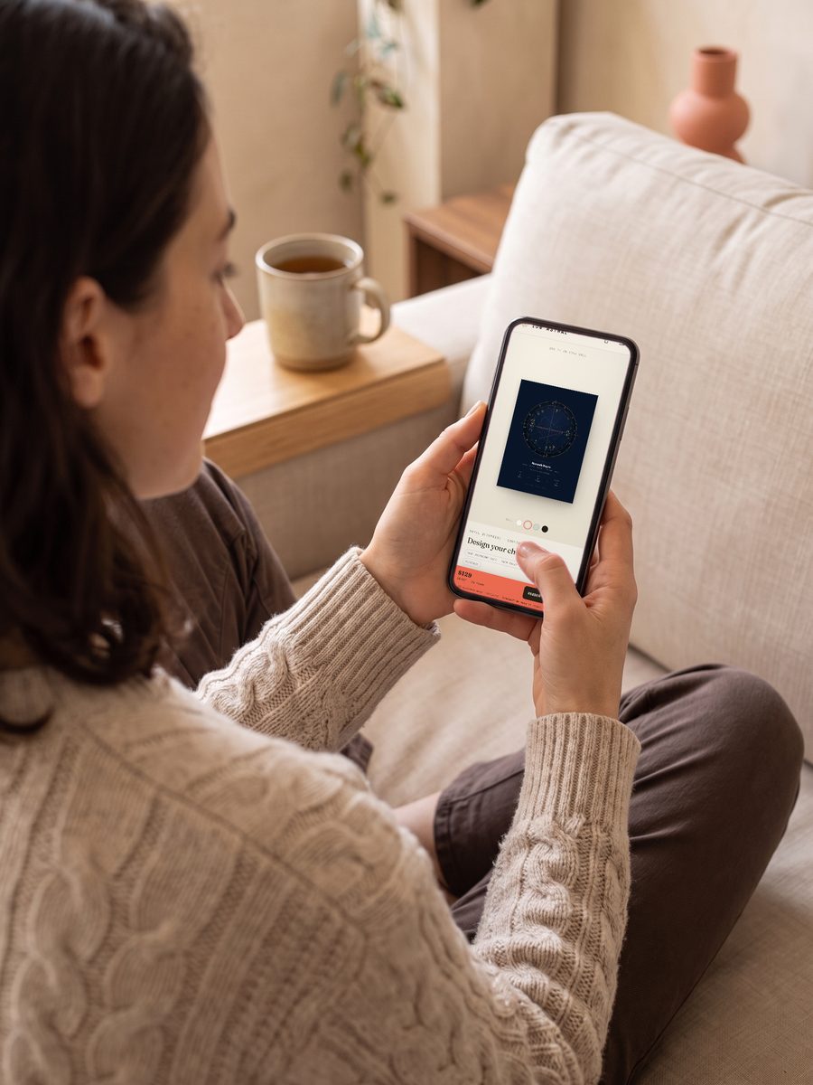 Looking at a personalized chart preview on a phone before ordering — scene, sample details shown